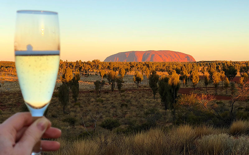 Raising a glass to Ayers Rock at sunset