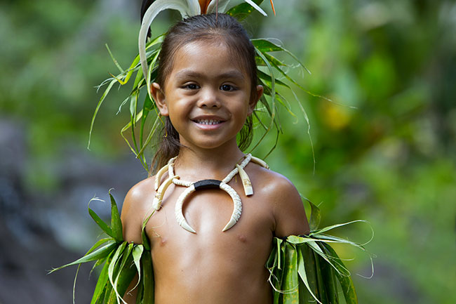 Local Child in French Polynesia Wearing Traditional Regalia