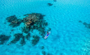 Paddleboarding in a Turquoise Cook Islands Lagoon