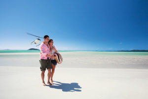 Couple on Whitehaven Beach, Australia, with Helicopter